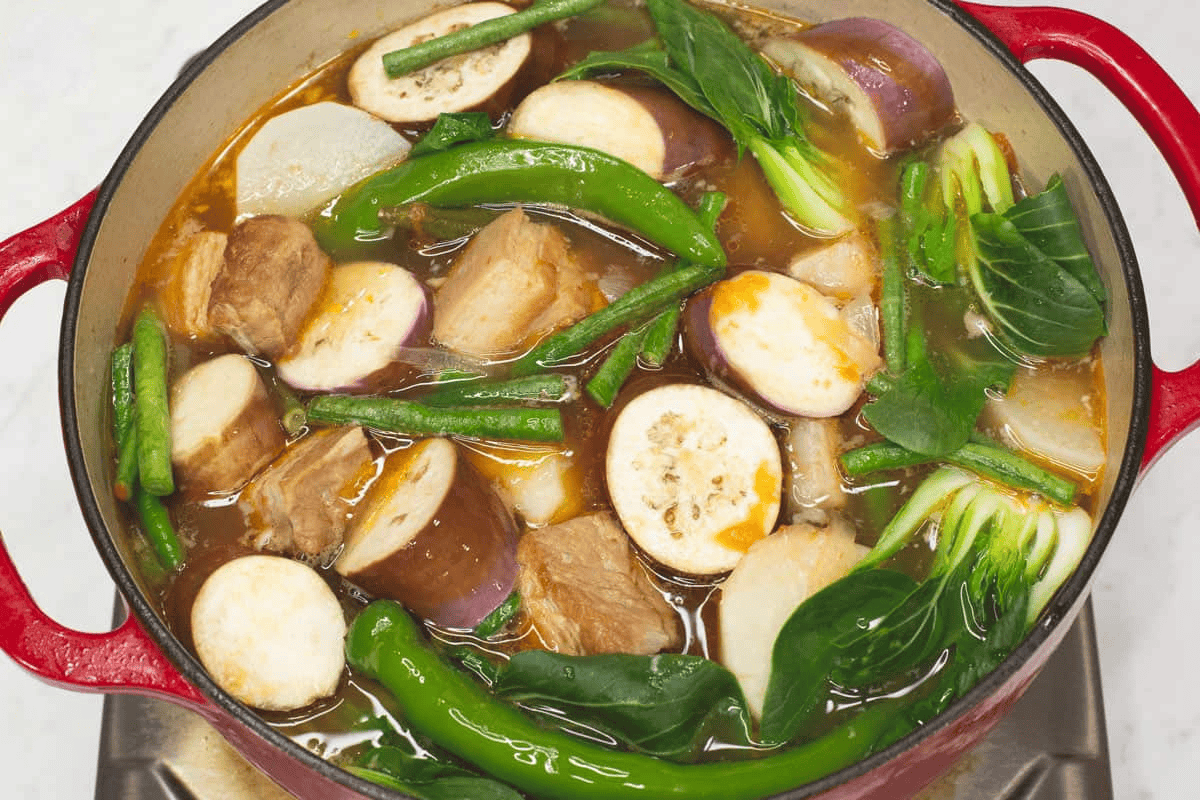 Added the greens and other vegetables to the mixture in the pot.