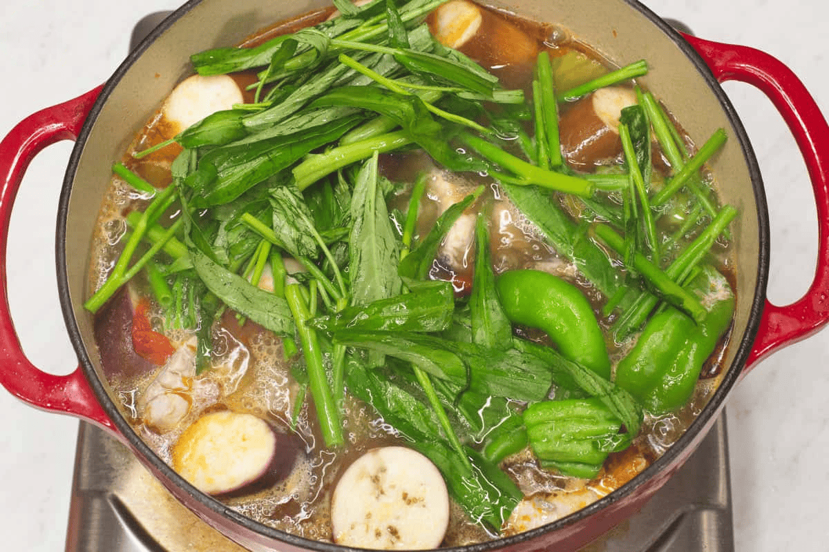 Added kangkong (water spinach) to the sinigang in the pot.