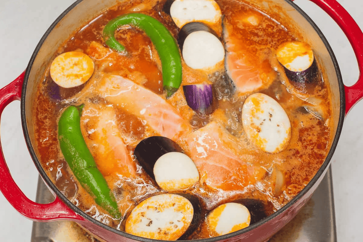 Added the fish and vegetables to the mixture in the pot.