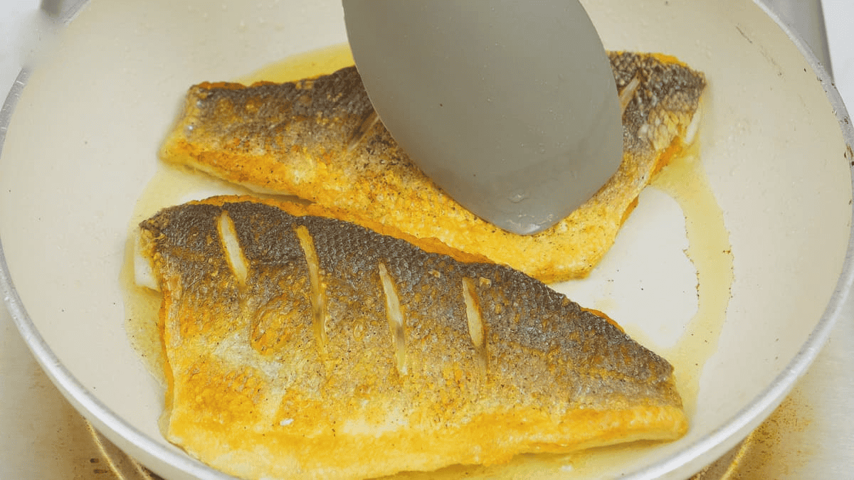 Pressing the fish against the pan. 