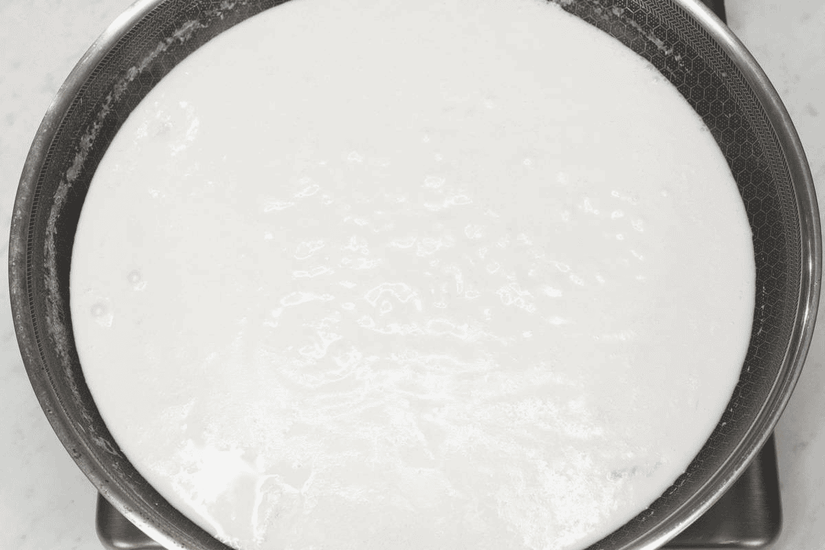Boiling coconut mixture in the skillet.