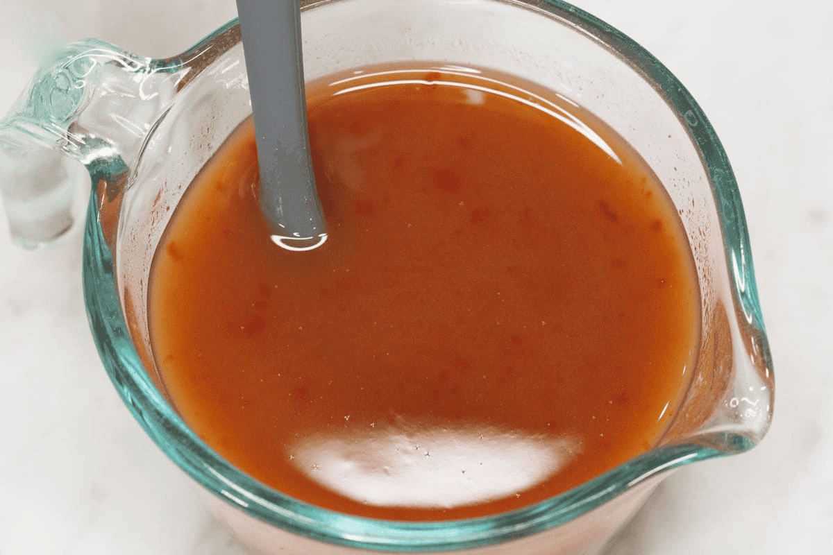 Mixing the sweet and sour sauce in a cup.