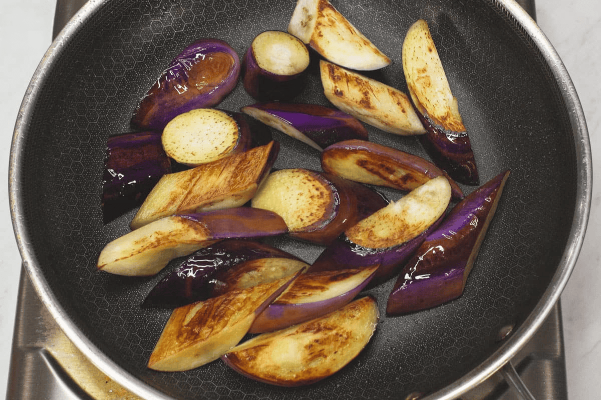 Seared eggplant on a skillet.