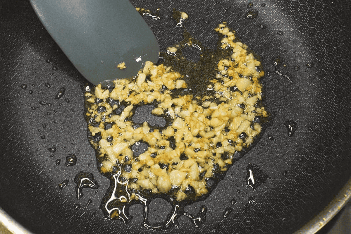 Sauteing garlic in a skillet.