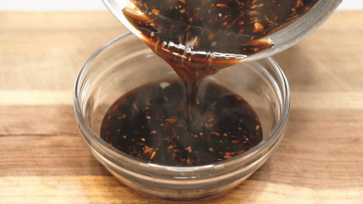 Pouring the teriyaki sauce into a bowl.