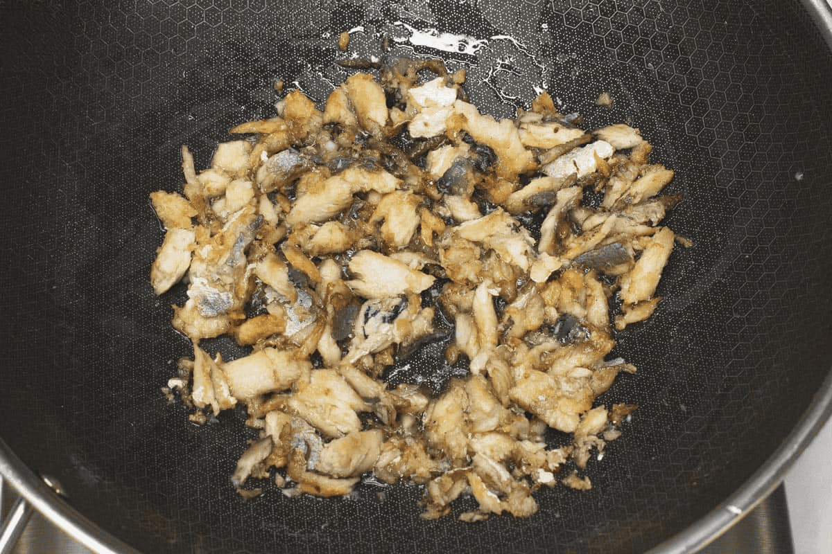 Toasting the tinapa flakes in a wok.