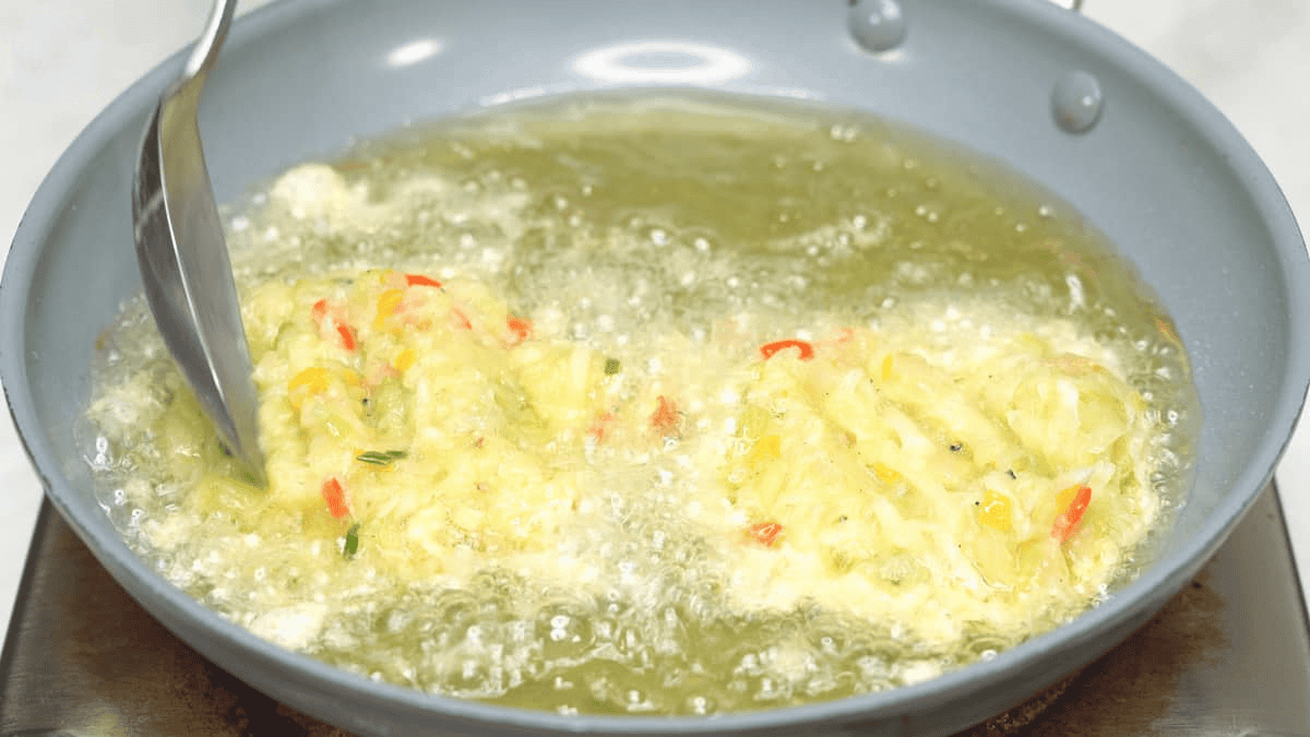 Added the chayote patties to the oil in the skillet.