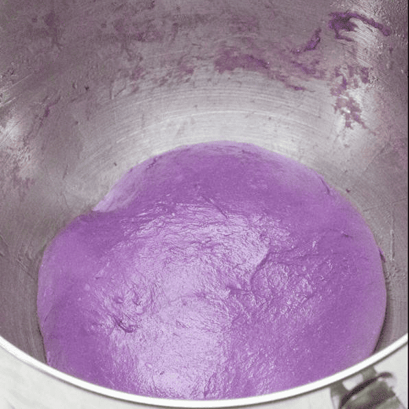 Ube dough before proofing in a bowl.