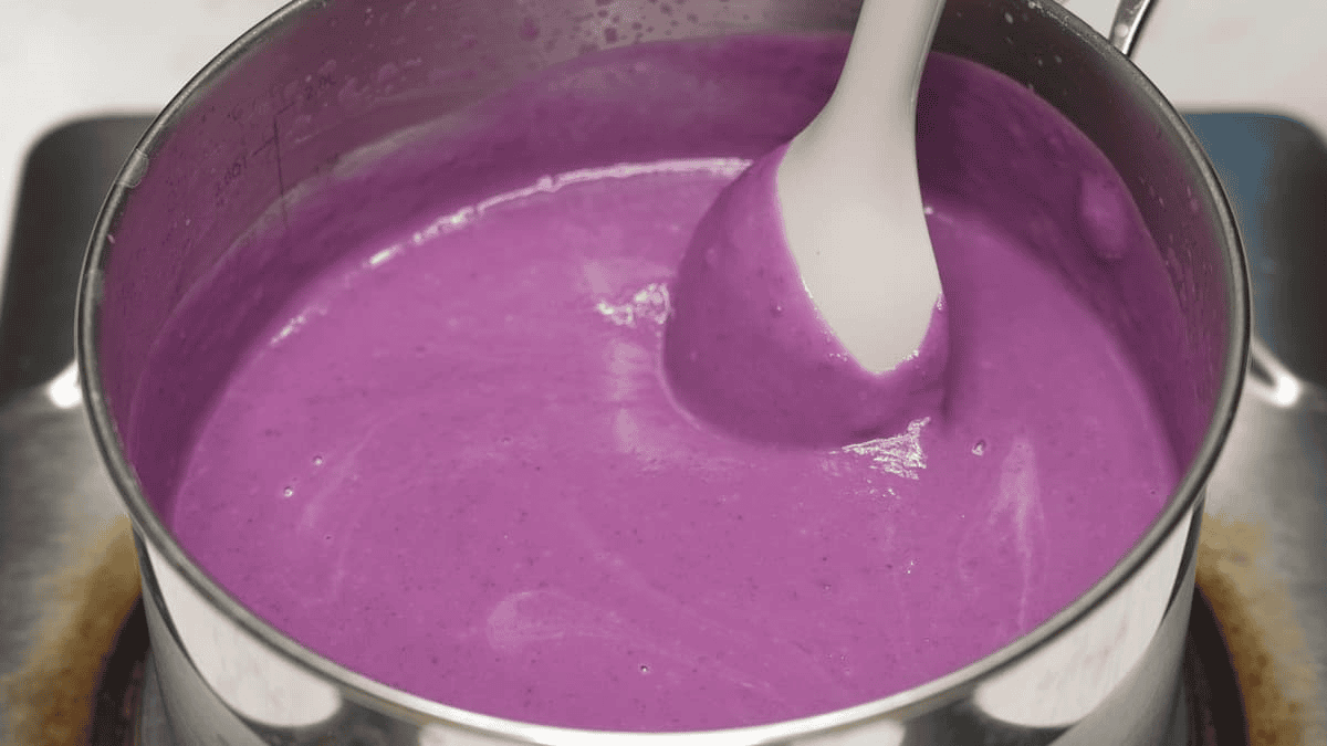 Mixing the blended ingredients of Ube Halaya (Purple Yam Jam) in a saucepan.