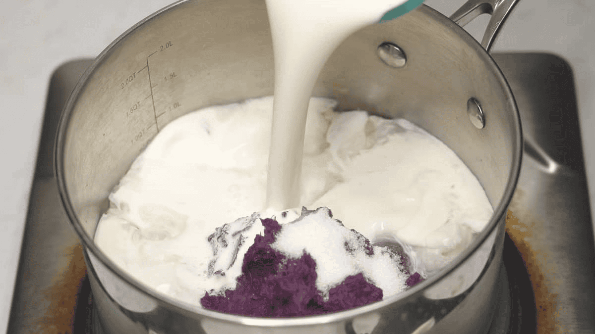 Combining the ingredients for Ube (Purple Yam) Ice Cream in a saucepan.