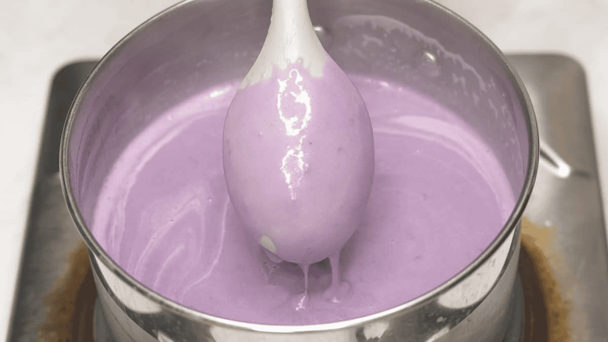 Thickened ice cream base coating the back of a spoon.