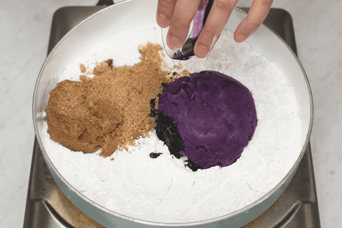 Combining the ingredients for Ube Kalamay in a saute pan.