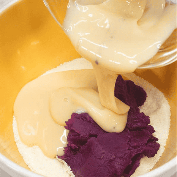 Adding condensed milk to the ube mixture.
