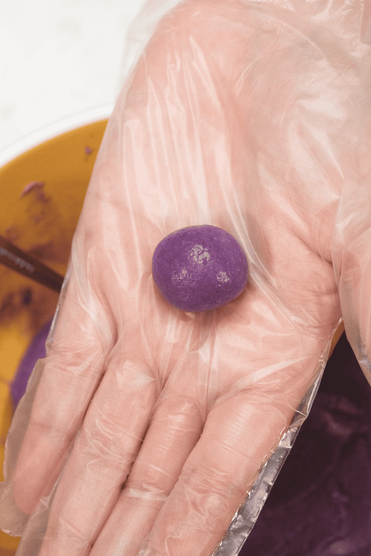 Rolling the Ube Pastillas into small balls.