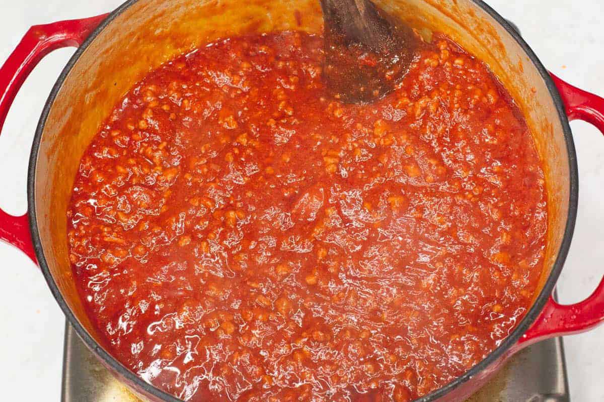 Mixing the pasta sauce in the pot.