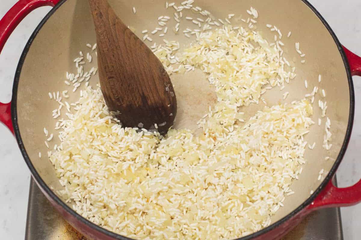 Stirring the rice mixture in the pot.