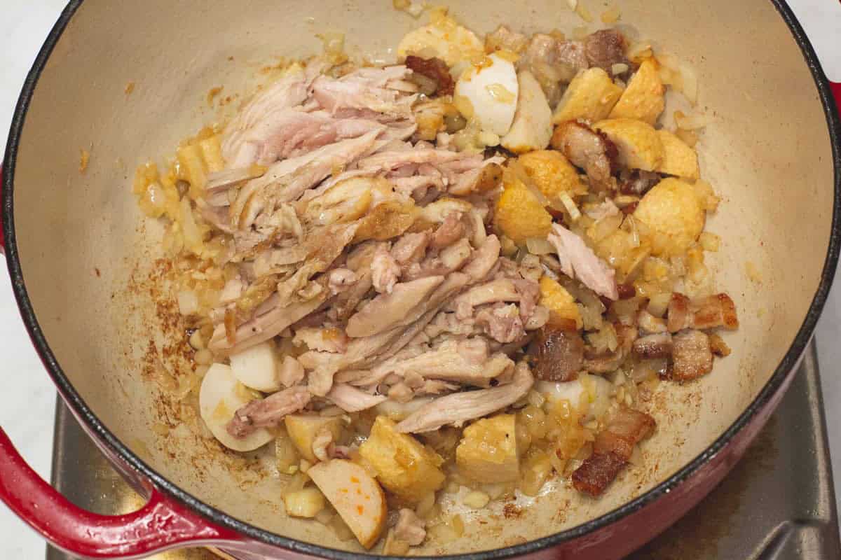 Added the shredded chicken and seafood balls into the pot.