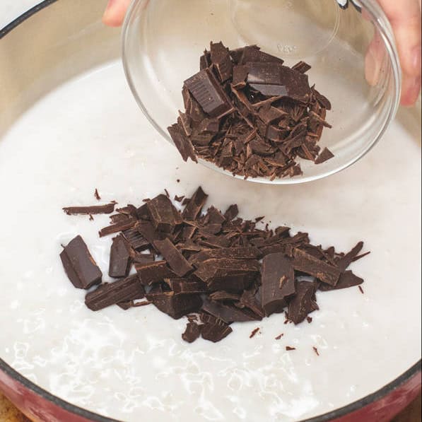 Adding the chocolate pieces and chocolate paste into the rice mixture.