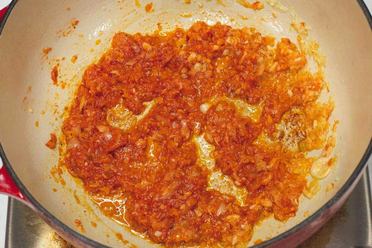 Browning the tomato paste in the pot.