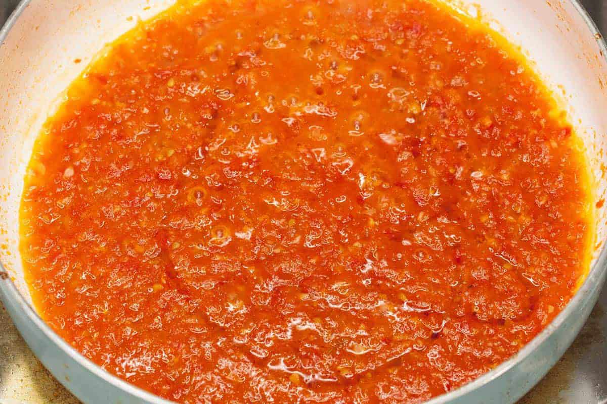 Simmering the sauce in the pan.