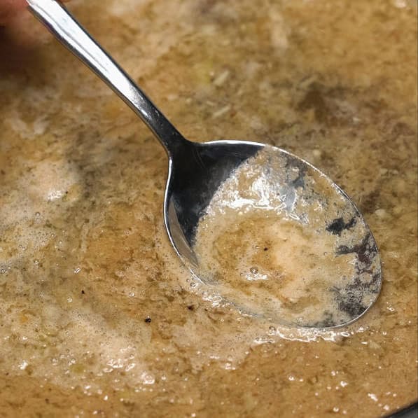 Skimming off the fat and foam on the surface. Adding pieces of beef chuck into the mixture.