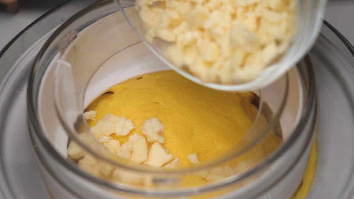 Adding the cheese while the ice cream is churning.