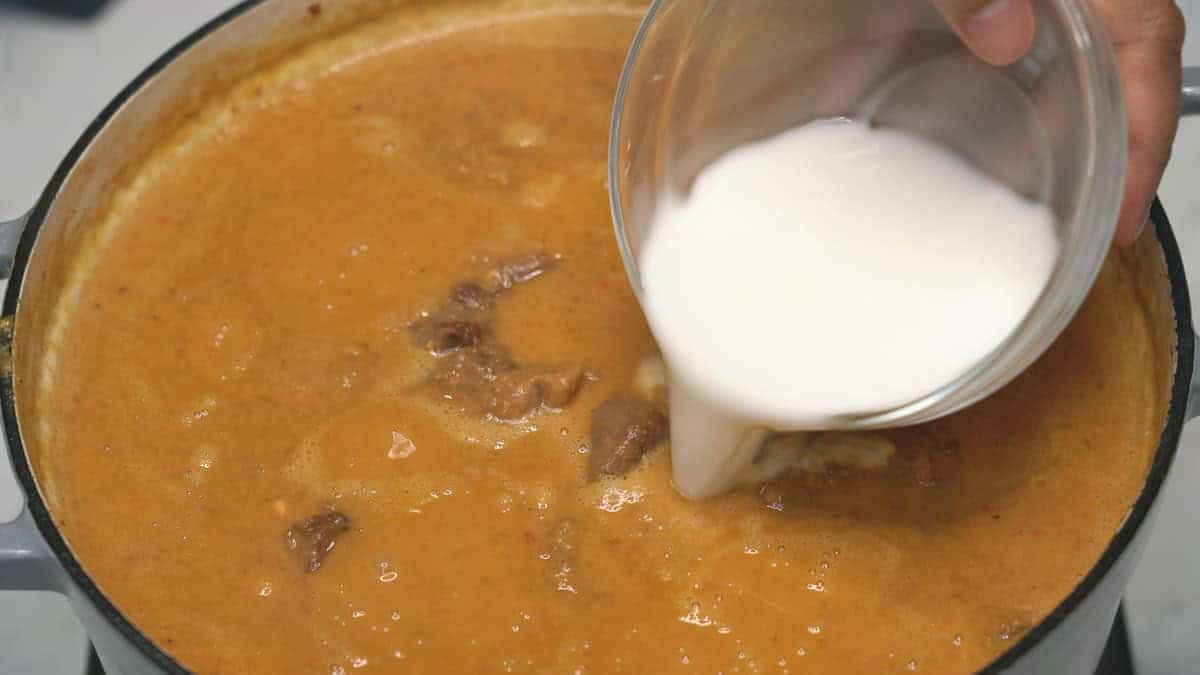 Adding cornstarch slurry into the mixture.