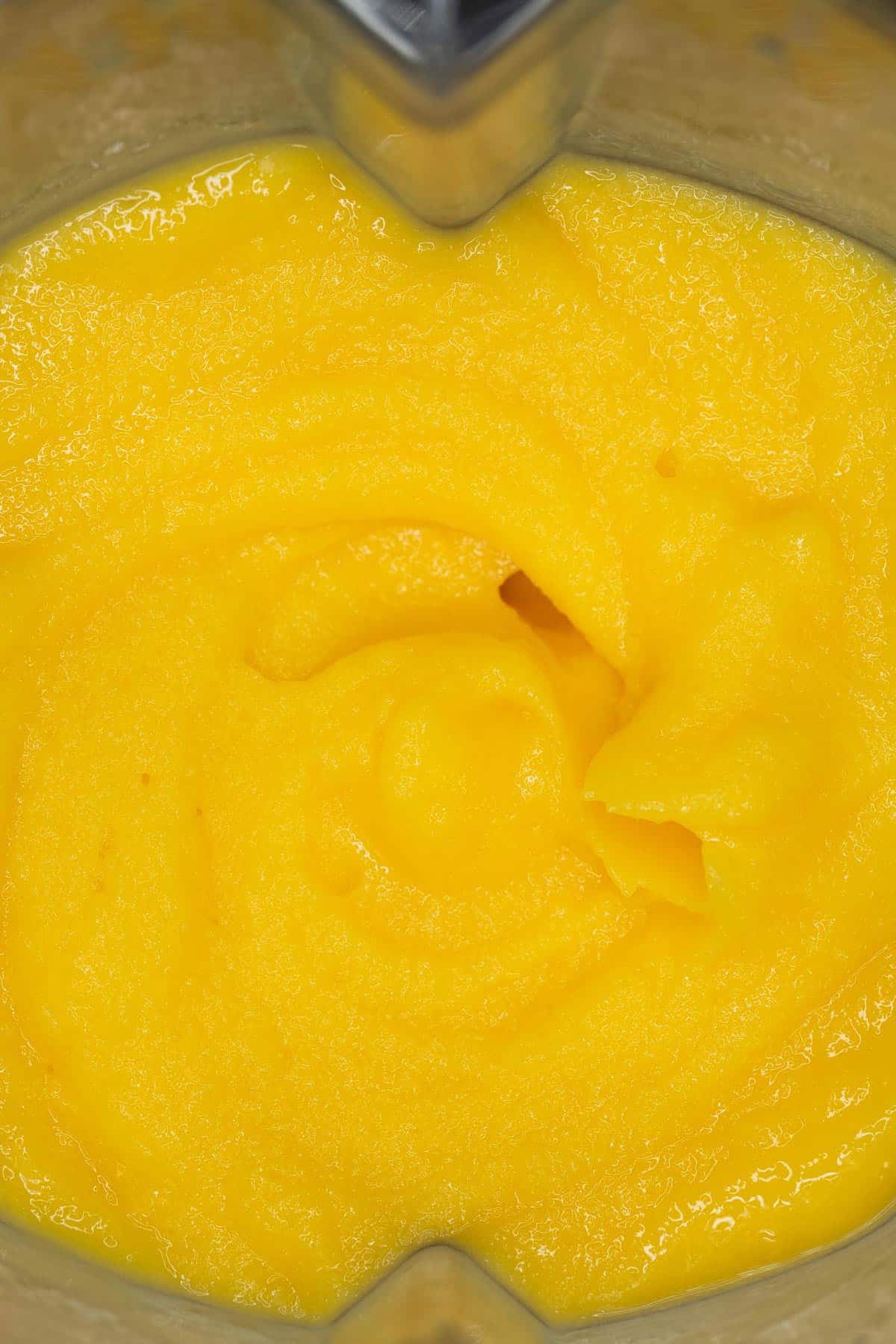 Blended mango shake in a blender.