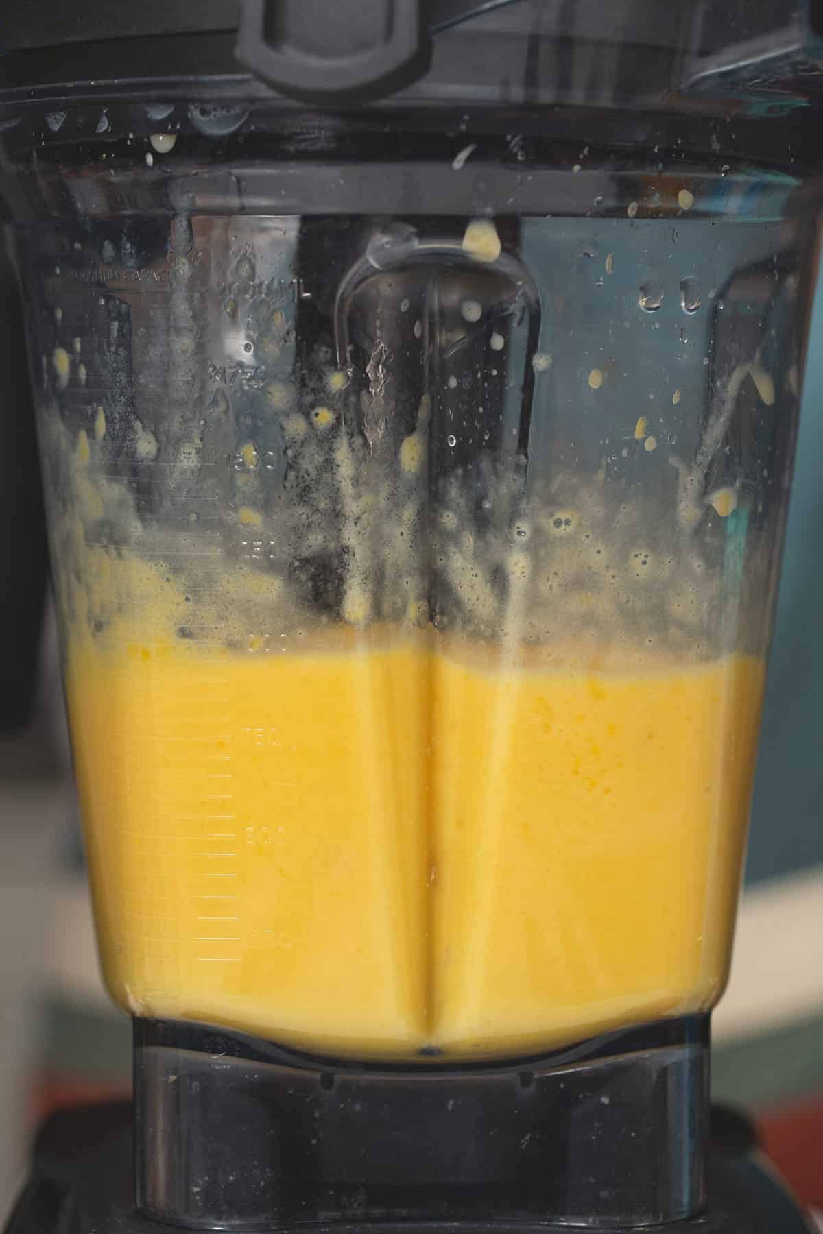 Blending mango shake in a blender.