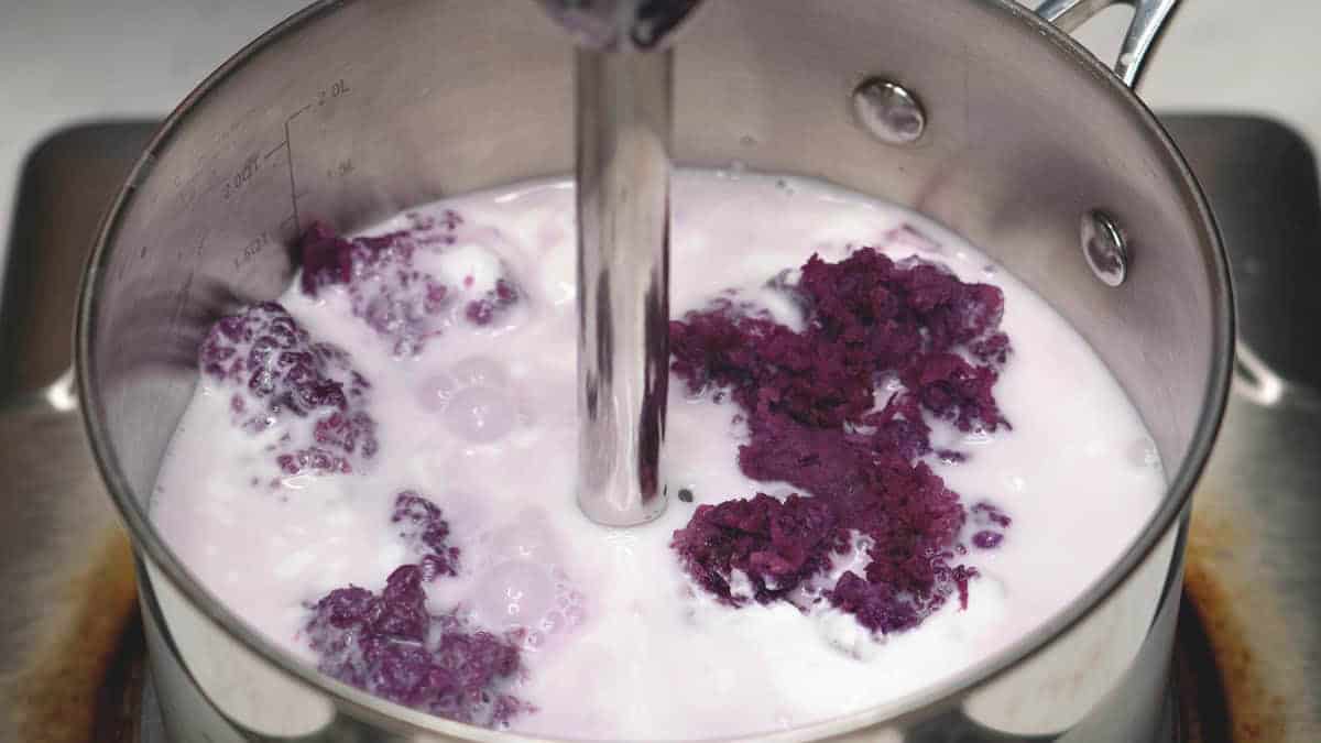 Blending the ingredients for Ube Halaya (Purple Yam Jam) in a saucepan.