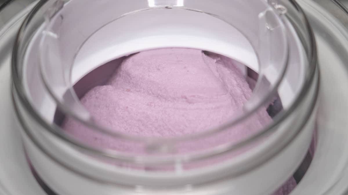 Churning the ice cream in an ice cream maker.