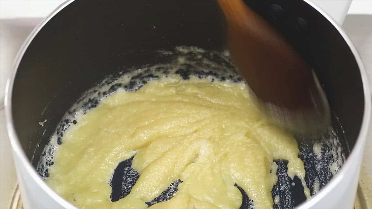 Mixing the roux in the saucepan.