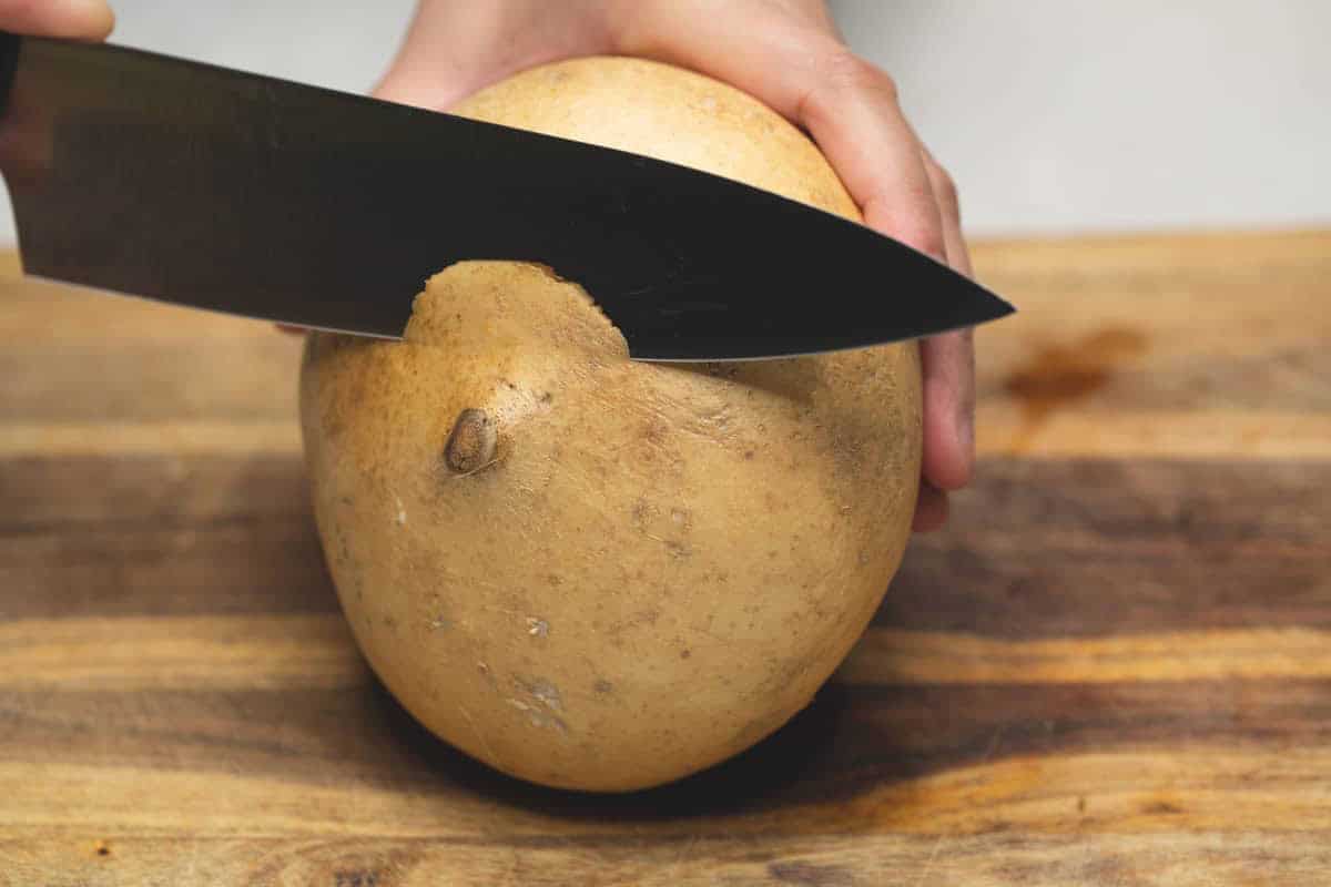 Cutting the root of jicama.