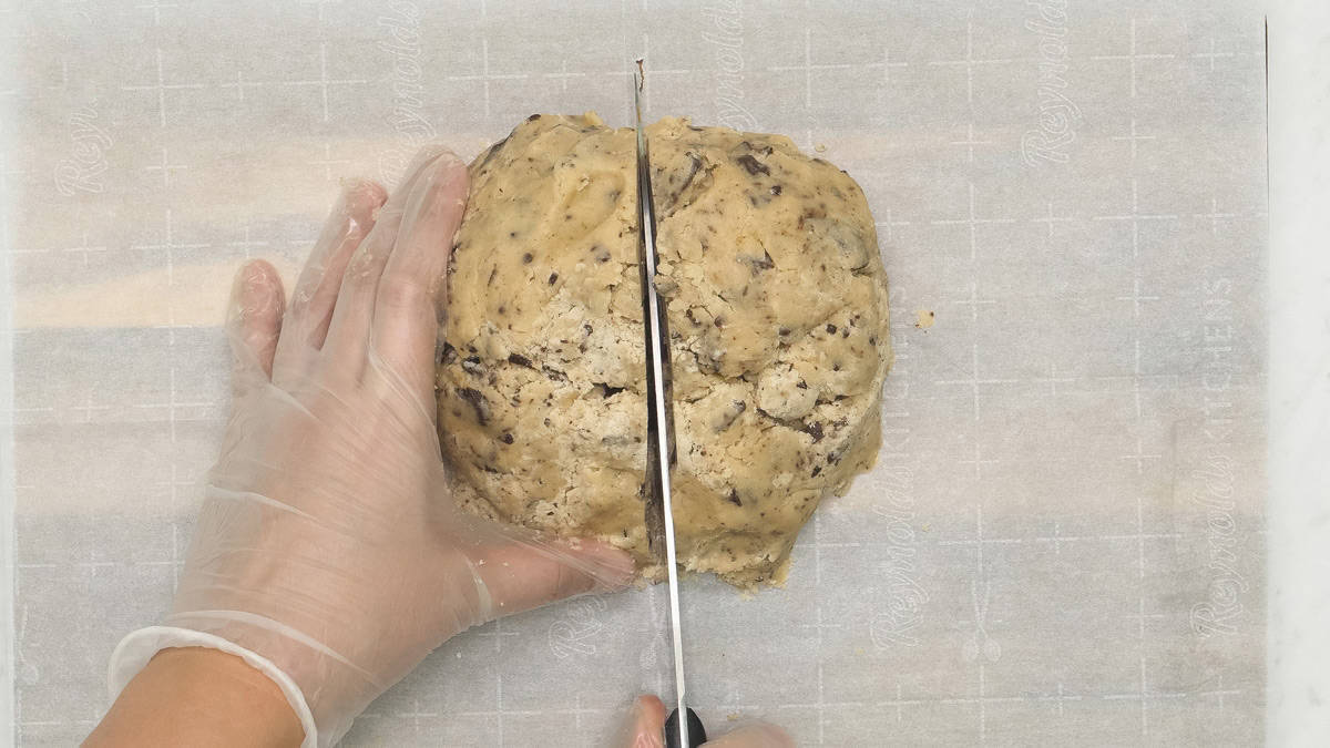Dividing the dough in half using a knife.