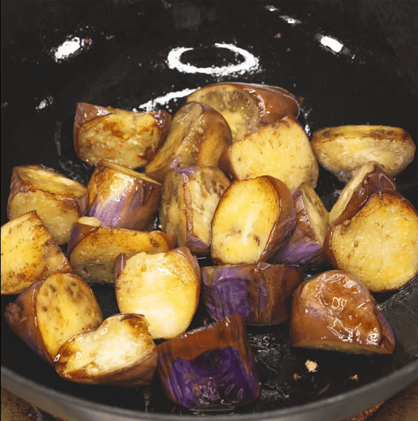 Searing the eggplant in the wok.