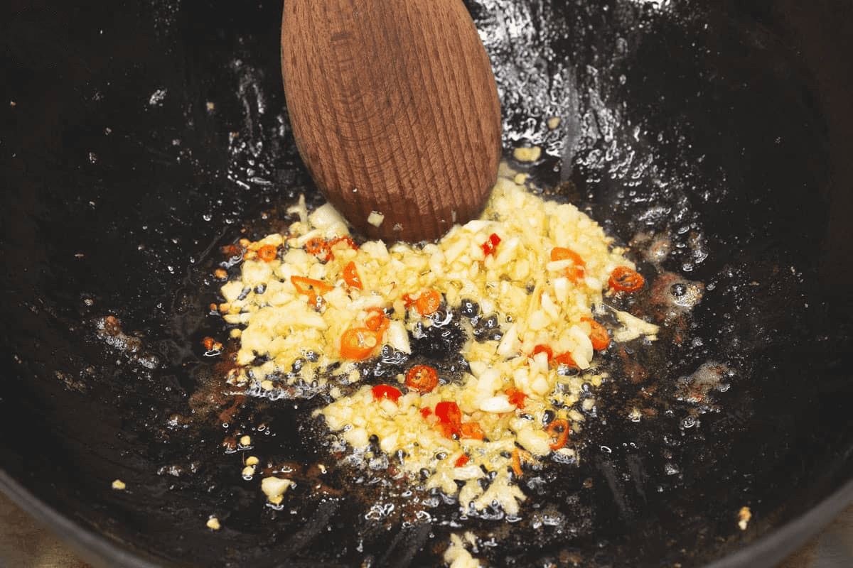 Sauteing the aromatics in the wok.