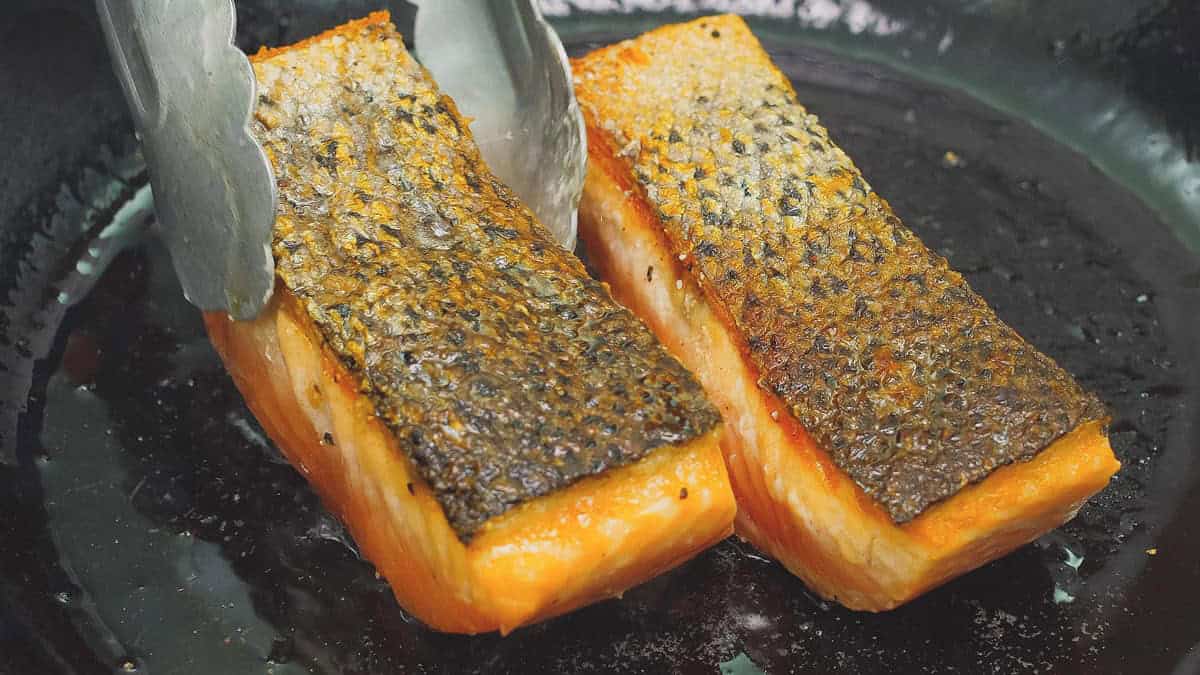 Flipped the salmon fillets to cook the other side.