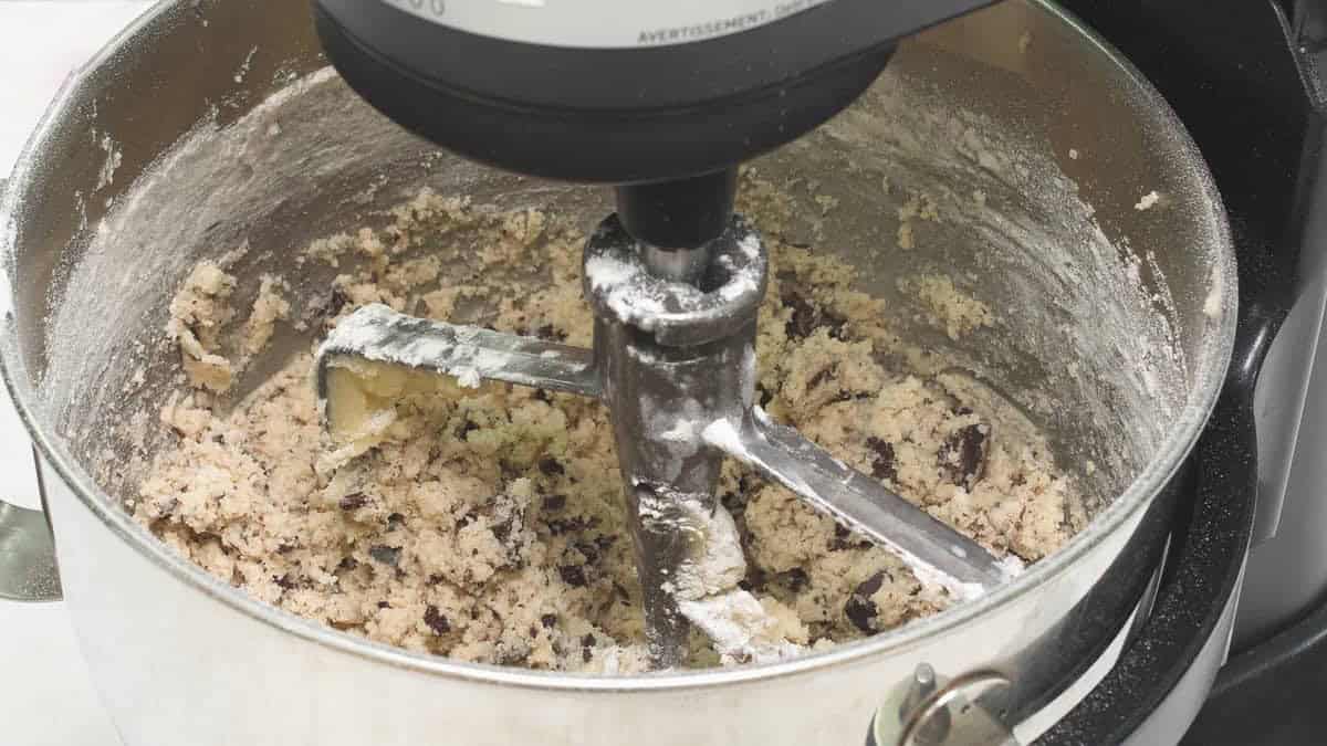 Cookie dough in the bowl of the stand mixer.