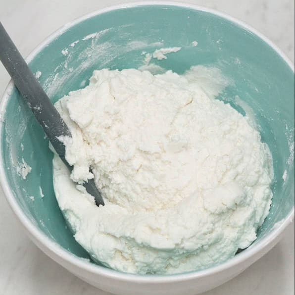 Mixing the dough and forming small balls, using your hands.