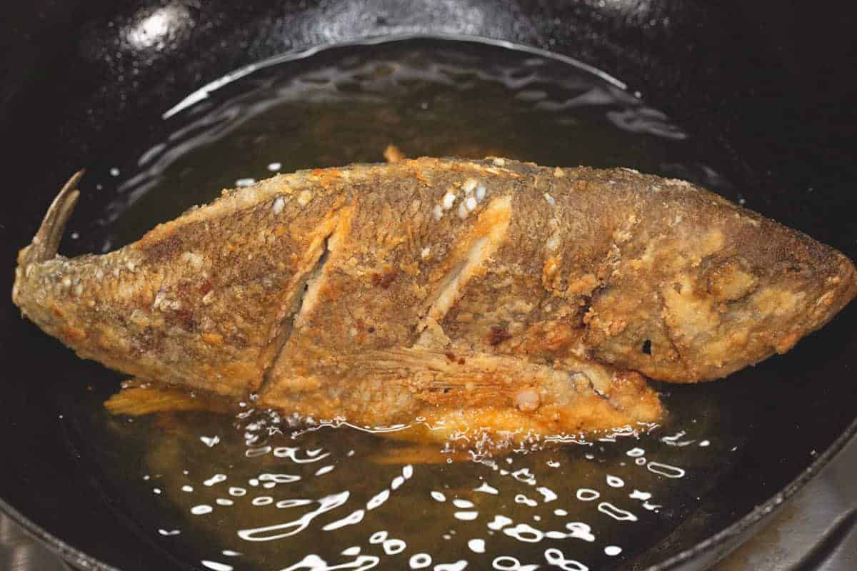 Frying the fish in a wok