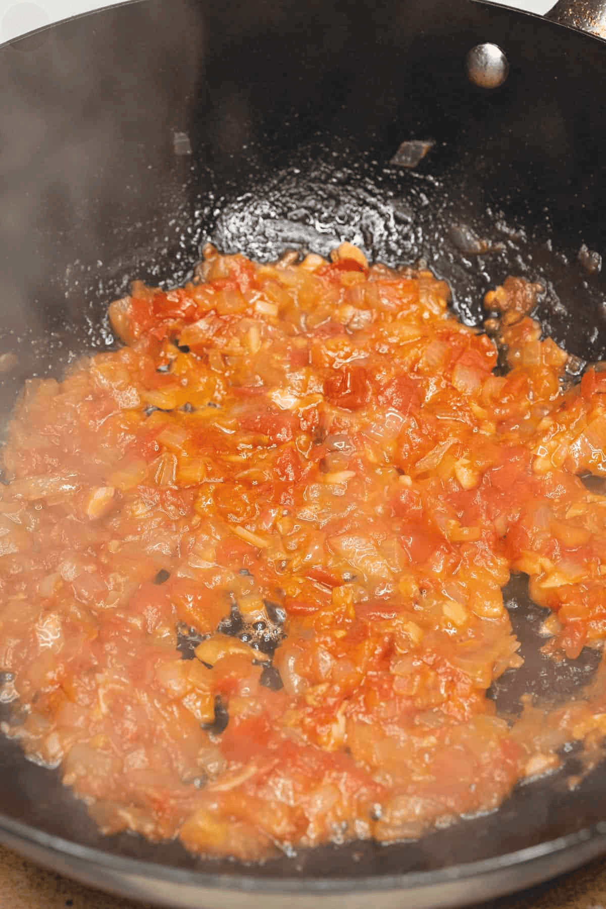 Caramelizing the aromatics in the wok.