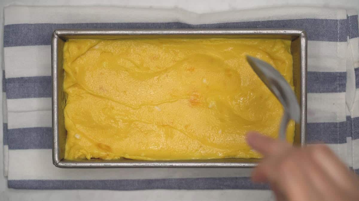 Spreading the churned ice cream in the loaf pan.