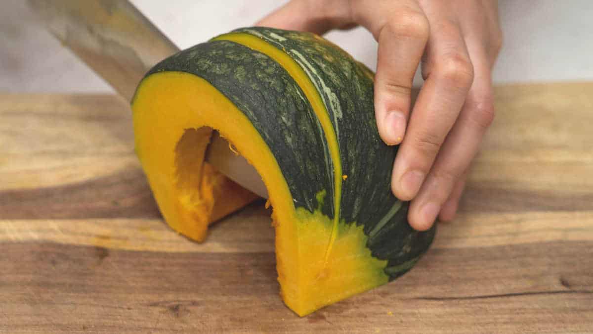 Slicing kabocha squash into wedges.