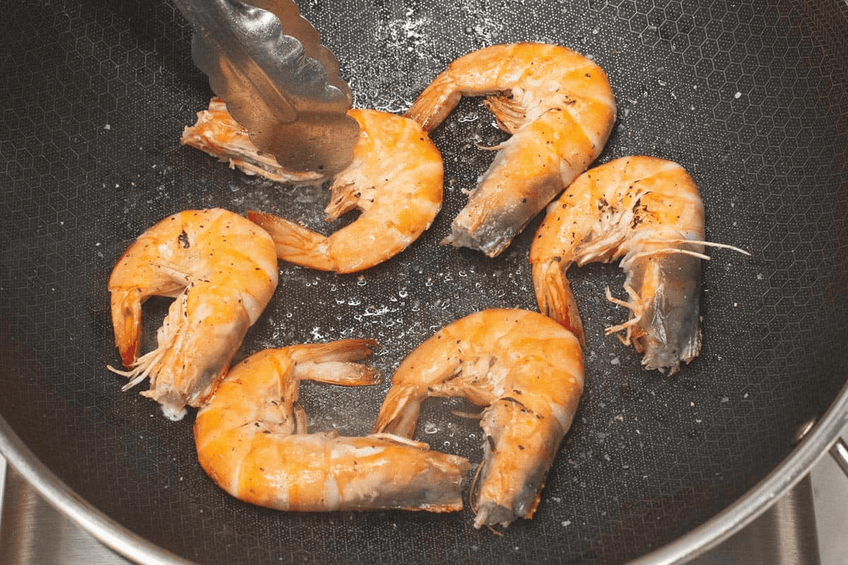 Searing the shrimp in the wok.