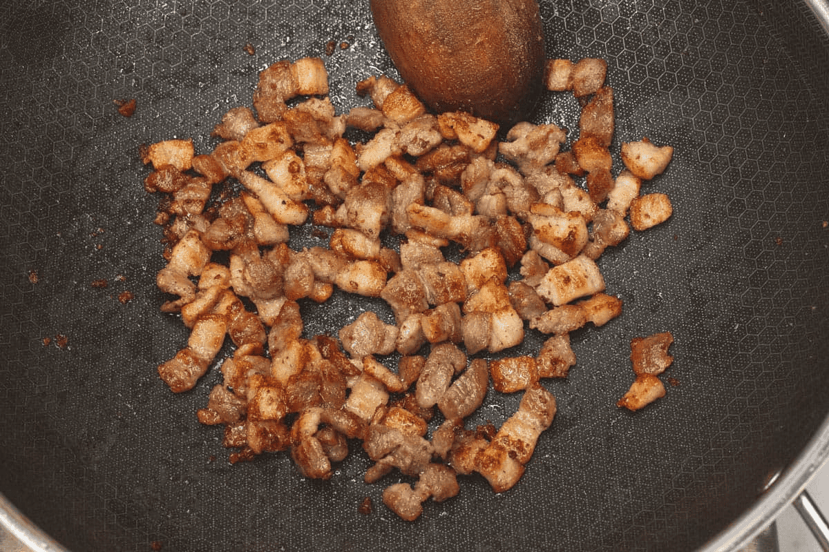 Browning the pork in the wok.