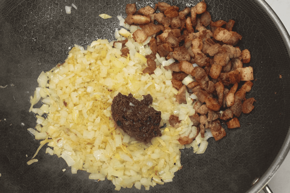 Added the shrimp paste with the aromatics and browned pork in the wok.