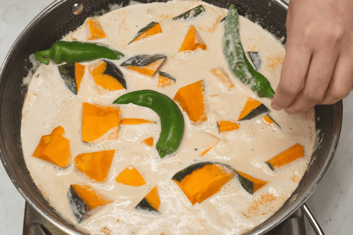 Added the kalabasa and chili peppers in the wok.