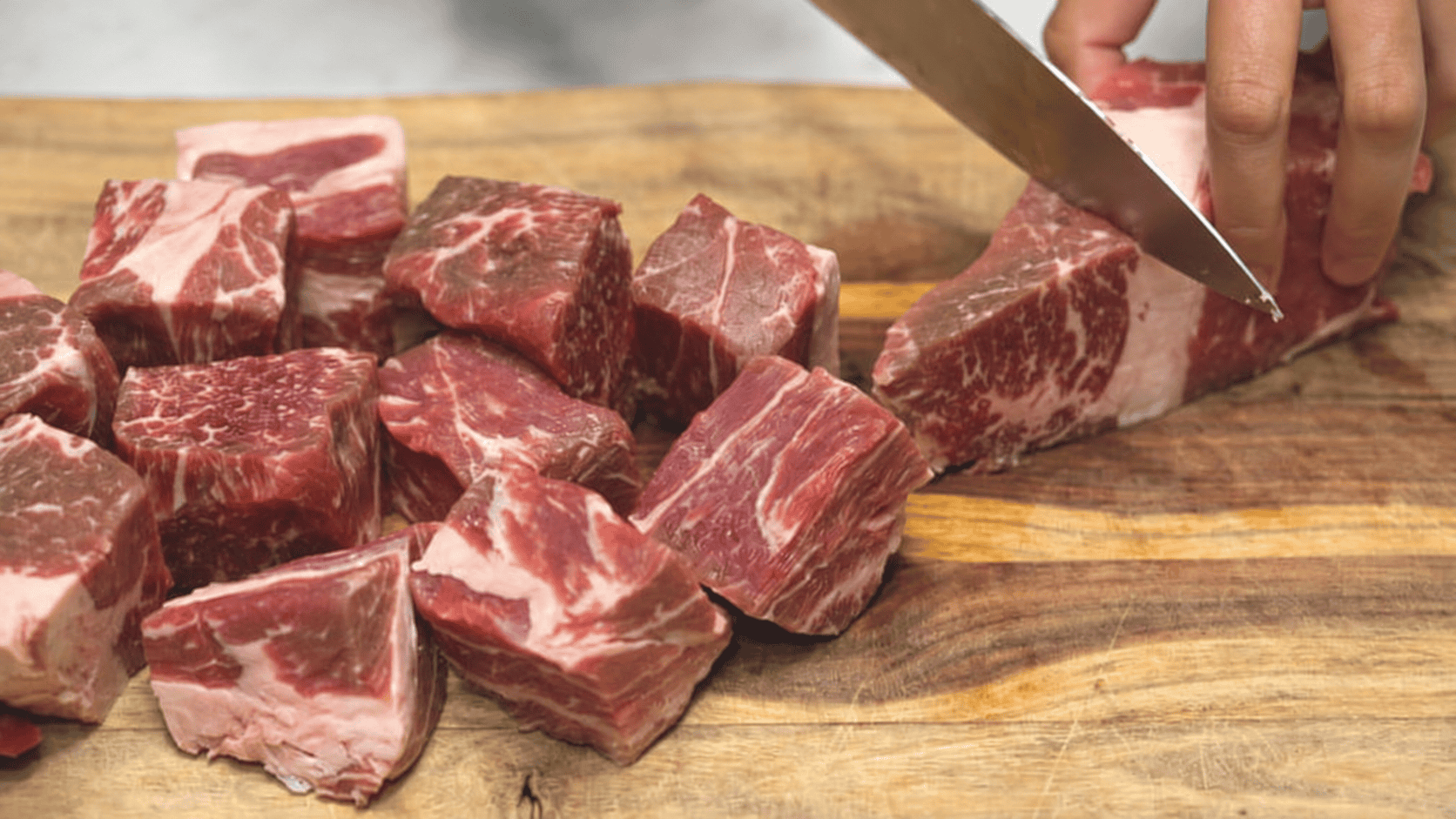 Cutting up the meat into chunks.