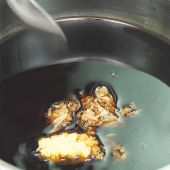 Combining the ingredients for teriyaki sauce. Adding cornstarch slurry to the simmering sauce.