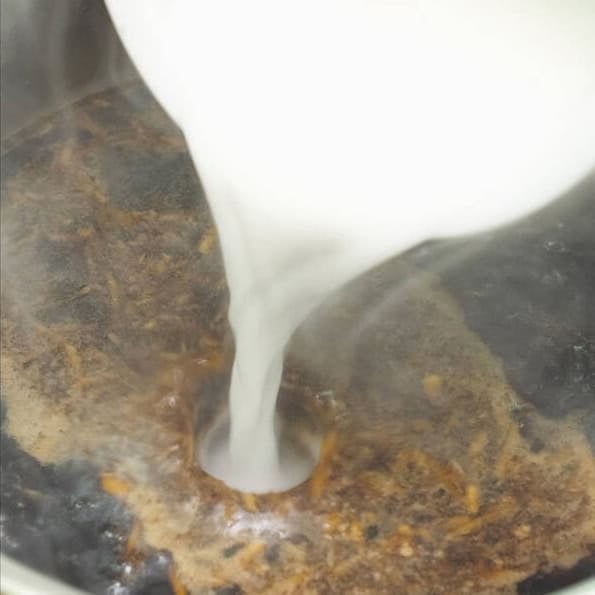 Combining the ingredients for teriyaki sauce. Adding cornstarch slurry to the simmering sauce.